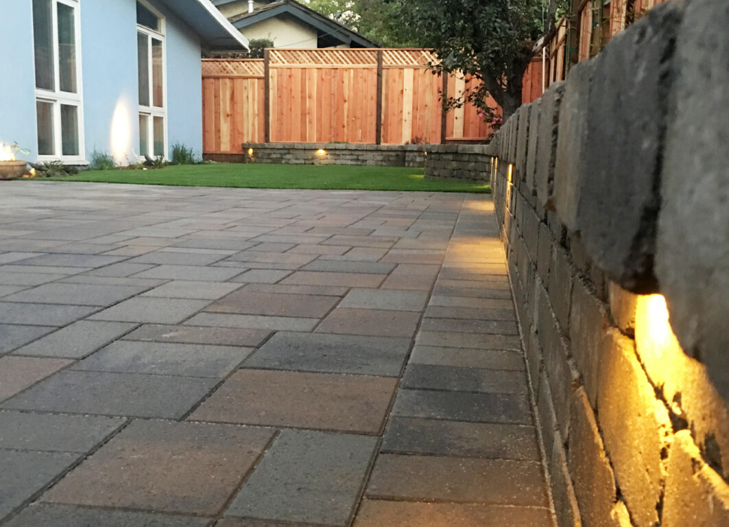 Custom concrete patio with lighting in Perth Amboy, NJ backyard